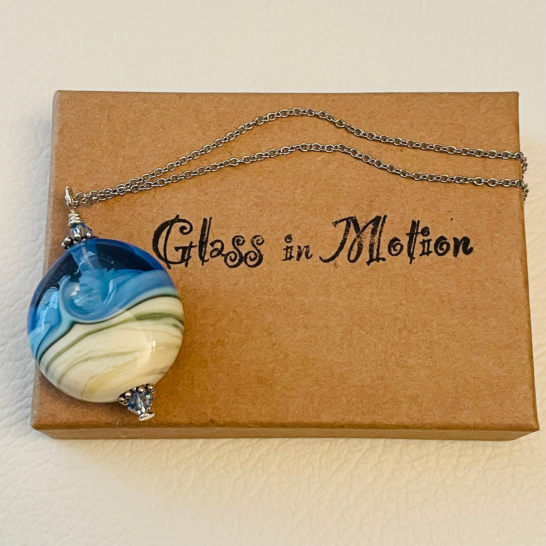 Garry White (Glass in Motion) - Necklace -  Lampwork pendant -round, clear blue sky, matte blue & cream by Garry White - Glass in Motion - McMillan Arts Centre - Vancouver Island Art Gallery