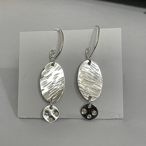 Laurie McDonald - Earrings - Textured Oval with tiny circle, sterling silver by Laurie McDonald - McMillan Arts Centre - Vancouver Island Art Gallery